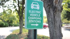 Image with green "EV Charging Stations" sign.