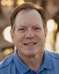 John Chalifoux, Chief Operating Officer of MEMA Aftermarket Suppliers, smiling outdoors in a professional headshot.