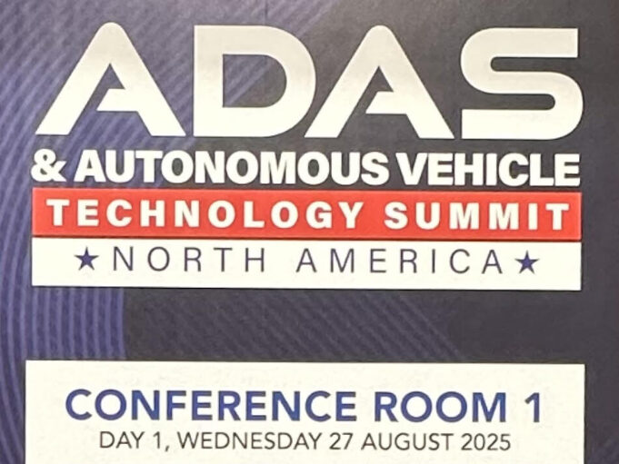 Conference agenda sign for the ADAS & Autonomous Vehicle Technology Summit North America 2025, showing sessions on deploying ADAS technologies, standards and regulations, safety innovations, and real-world testing across August 27–28, 2025.